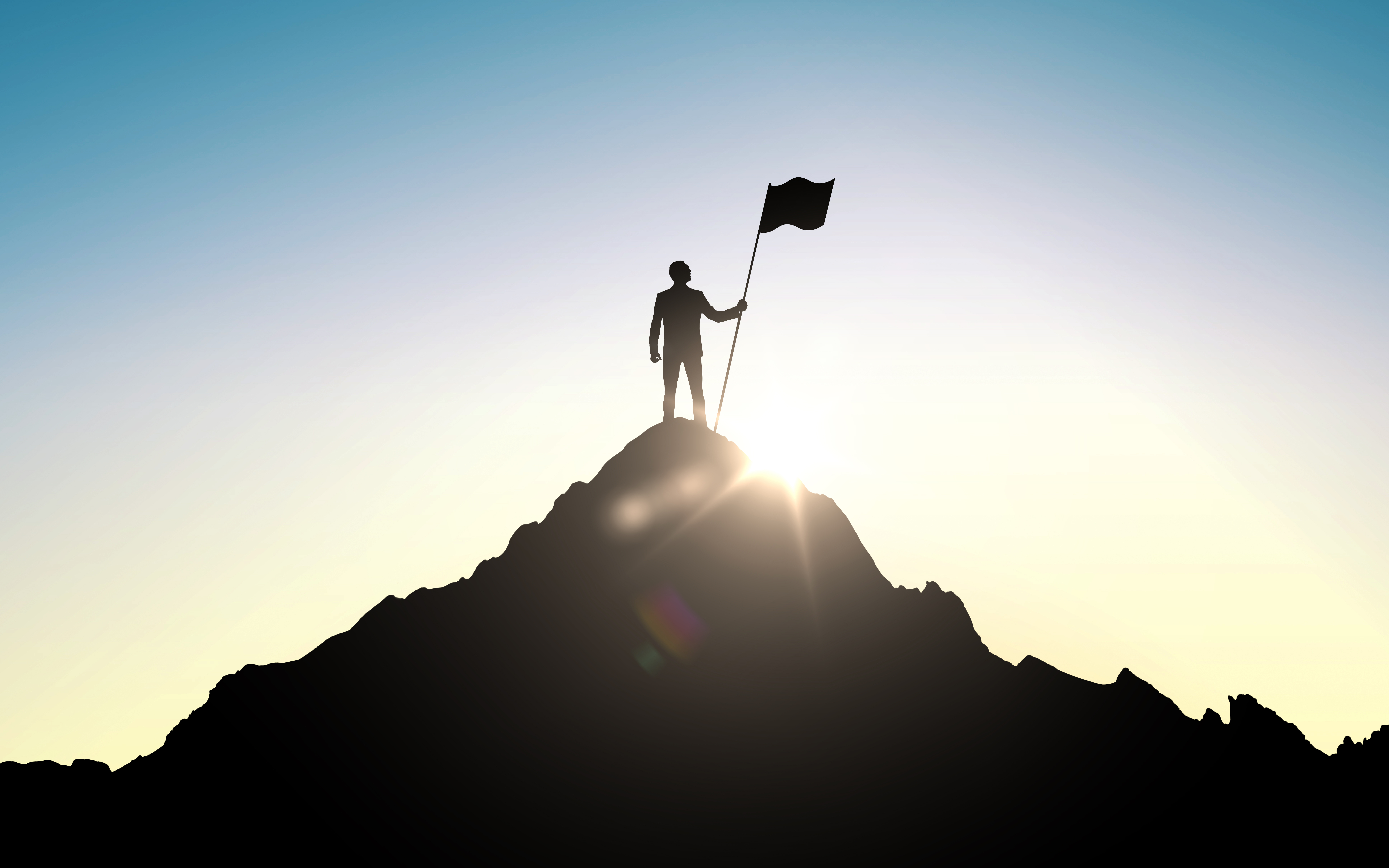 picture of a person at the top of a mountain with a flag